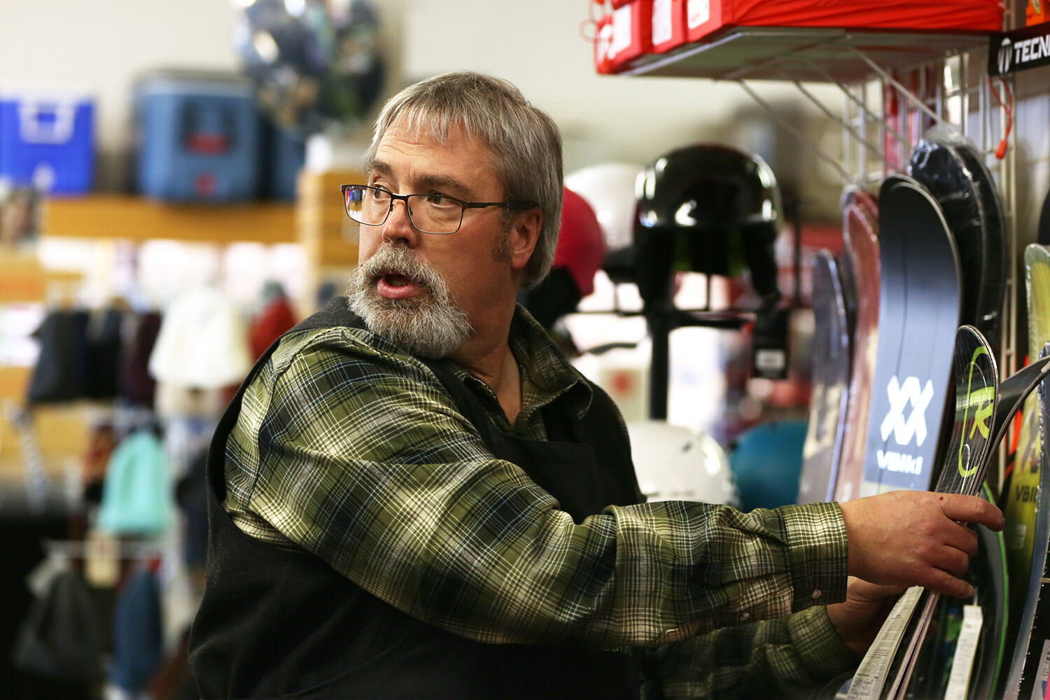 Luke Todd talks with a customer about a problem with his ski’s